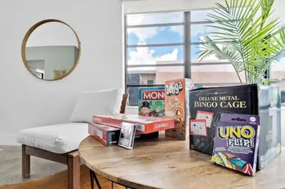 a pile of boxes on a table in a living room at Modern Pool Home Great for Families in Hollywood
