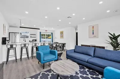 a living room with a couch and a table at Modern Home 3 Bedrooms with Pool, 18 minutes to Ocean in Hollywood