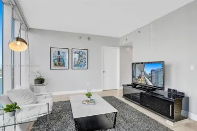 a white living room with a tv and a couch at Waterfront Luxury Apartment 2 Bedrooms IconBrickell in Miami