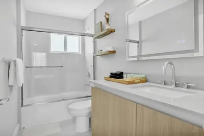 a bathroom with a sink and a toilet and a shower at Sistrunk Shades Villas Units #1 & #2 Combined in Fort Lauderdale