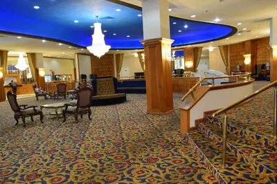 a lobby with chairs and a staircase in a hotel at Beachfront Property Pool Gym Tennis Miami Beach! in Miami Beach