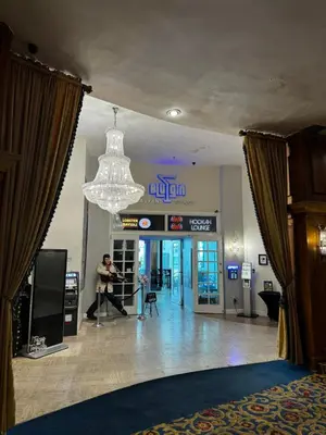 a man is dancing in a room with a chandelier at Beachfront Property Pool Gym Tennis Miami Beach! in Miami Beach