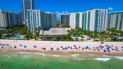 an aerial view of a beach with umbrellas and the ocean at Tides Ocean Retreat by Cielo Stays in Hollywood