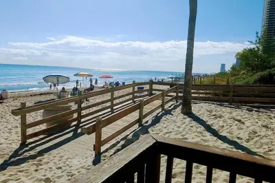 a sandy beach with umbrellas and people on the beach at Tides Ocean Retreat by Cielo Stays in Hollywood