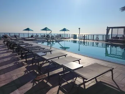 a row of tables and chairs next to a swimming pool at Luxury Ocean Escape by Cielo Stays in Hollywood