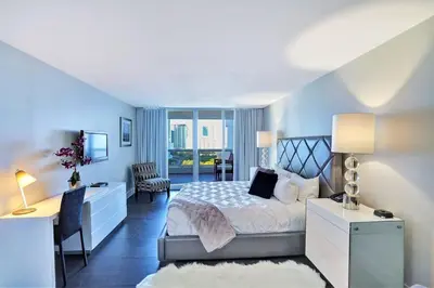 a bedroom with a bed and a desk and a chair at Miami Vibes! Biscayne Bay Water and Park Views! in Miami