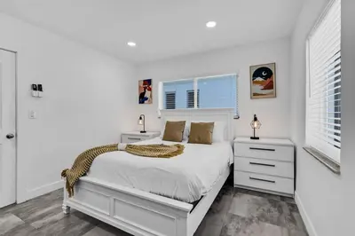 a white bedroom with a bed and a window at Lovely 1 Bedroom Walking Distance To Ocean - Suite 9 in Hollywood