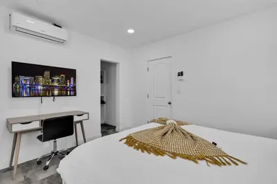 a white bedroom with a bed and a desk at Lovely 1 Bedroom Walking Distance To Ocean - Suite 9 in Hollywood