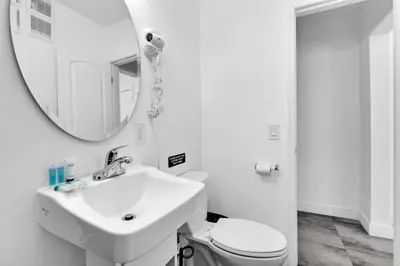 a white bathroom with a sink and a mirror at Lovely 1 Bedroom Walking Distance To Ocean - Suite 9 in Hollywood