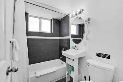 a bathroom with a sink and a toilet and a tub at Lovely 1 Bedroom Walking Distance To Ocean - Suite 9 in Hollywood