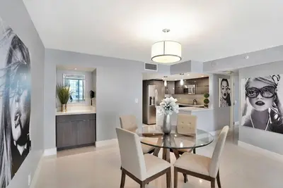 a dining room with a glass table and chairs at SeaDuced By Miami Skyline And Bay Views! in Miami