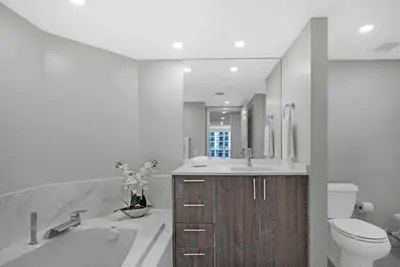 a bathroom with a tub and a toilet and a sink at Electric Love Brand New With Water View, Edgewater in Miami