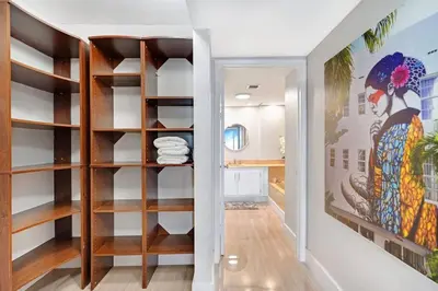 a hallway with wooden shelves in a house at Endless Summer! Incredible Water Views in Miami