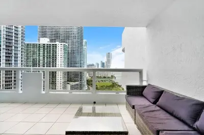 a living room with a couch and a large window at Endless Summer! Incredible Water Views in Miami