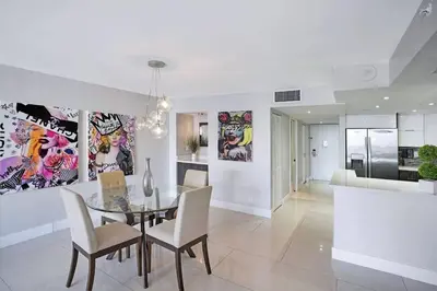 a dining room with a glass table and chairs at Dreamscape! Renovated and spacious 1 bedroom condo in Miami