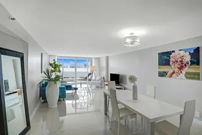 a dining room and living room with a table and chairs at Sin City! Brand new and water view! in Miami