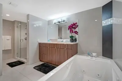 a bathroom with a tub and a sink and a mirror at Sin City! Brand new and water view! in Miami