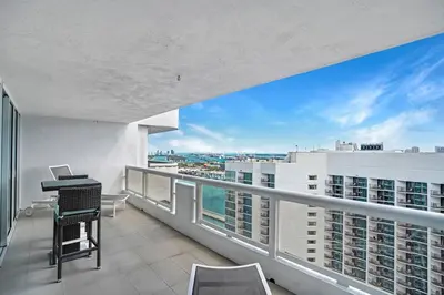 an apartment balcony with a view of the ocean at Sin City! Brand new and water view! in Miami