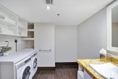 a white laundry room with a washer and dryer at Wait N' Sea! Direct Water Views, Steps From Pool! in Miami