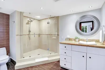 a bathroom with a tub and a toilet and a sink at Wait N' Sea! Direct Water Views, Steps From Pool! in Miami