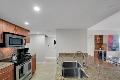 a kitchen with a sink and a stove at Permanent Vacation! Direct Water Views! in Miami