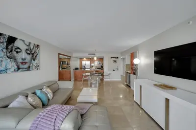 a living room with a couch and a flat screen tv at Permanent Vacation! Direct Water Views! in Miami