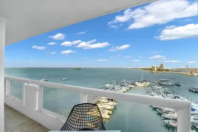 a balcony with a view of a harbor with boats at Permanent Vacation! Direct Water Views! in Miami
