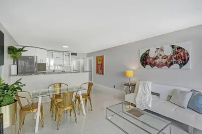 a living room with a table and a couch at Dance with me! Water and Park Views! in Miami