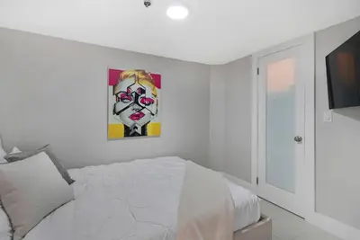 a bedroom with a bed and a painting on the wall at Dance with me! Water and Park Views! in Miami
