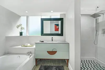 a bathroom with a sink and a tub and a mirror at The Palms! Direct water view corner condo in Miami
