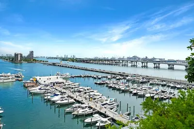 a bunch of boats are docked in a harbor at Only in My Dreams! Direct Water View Luxury Condo in Miami