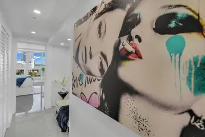 a large painting of a woman on a wall in a room at Walking on Water! Water Views! in Miami
