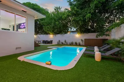 a swimming pool in the backyard of a house at Beautiful Villa with heated pool Must seen! in Miami