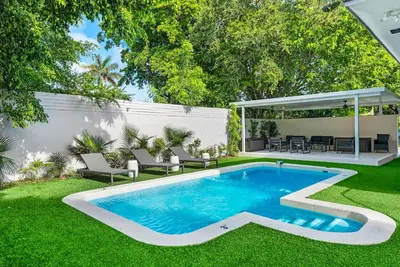 a backyard with a swimming pool and a gazebo at Beautiful Villa with heated pool Must seen! in Miami
