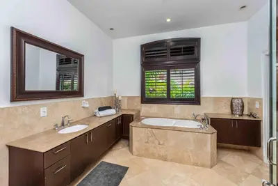 a large bathroom with two sinks and a mirror at Villa sleeps 18 in Miami Shores with Movie theater / Pool / Jacuzzi in Miami