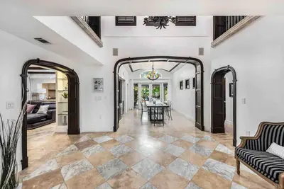 a living room with an archway and a dining room at Villa sleeps 18 in Miami Shores with Movie theater / Pool / Jacuzzi in Miami
