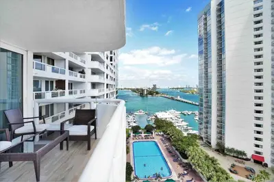 an apartment balcony with a view of the water at Aqua Marina! Water & City Views! in Miami