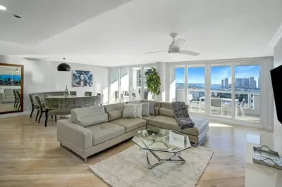 a living room with a couch and a table at Over The Moon! Miami Skyline and Water Views! in Miami