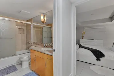 a bathroom with a sink and a toilet and a bed at Over The Moon! Miami Skyline and Water Views! in Miami
