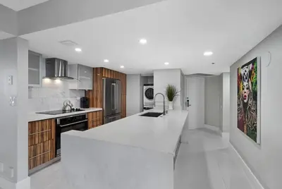 a white kitchen with a large white counter top at The Queen B! Water & Skyline Views - Renovated in Miami