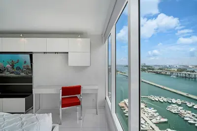 a bedroom with a desk and a view of a harbor at Seas The Day! Complete Panoramic Water Views in Miami