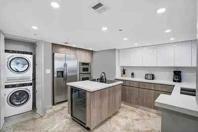a kitchen with a washing machine and a washer and dryer at First Class! - Crystal clear water views! in Miami