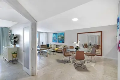 a living room with a table and a couch at Good Morning Beautiful! Direct Water Views in Miami
