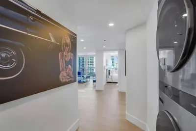 a living room with a kitchen and a refrigerator at Make It Happen! Brand New with Amazing Water Views in Miami