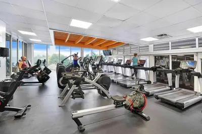 a gym with several treadmills and people on bikes at Make It Happen! Brand New with Amazing Water Views in Miami