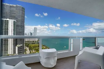 a balcony with a view of the ocean from a building at Make It Happen! Brand New with Amazing Water Views in Miami