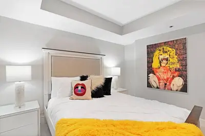 a bedroom with a bed with a large painting on the wall at Enchanted! Miami Skyline & Water Views in Miami