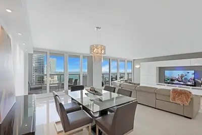 a living room with a dining table and a couch at Obsession! Water & Park Views in Miami