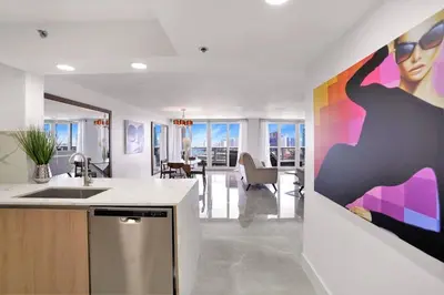 a kitchen with a large painting of a woman at Classic Beauty! Skyline and water views in Miami