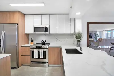 a kitchen with a stove and a sink in it at Classic Beauty! Skyline and water views in Miami